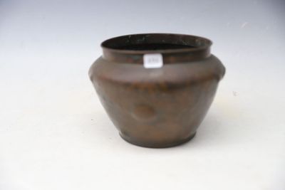 a brown vase sitting on a white surface