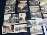 several old black and white photographs of people and buildings on a table
