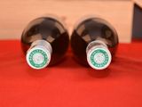two bottles of wine that are sitting on a table