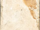 a close up of an old, dirty tile with a black background