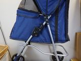 a blue stroller that is sitting on a wooden floor