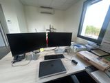 a desk with two computer monitors and a laptop on it