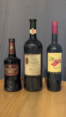 three bottles of wine sitting on a table next to each other