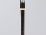 a close up of a black and white flute on a clear surface