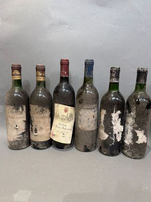 several bottles of wine are lined up in a row on a table