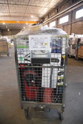 a metal cart with a sign on it in a warehouse