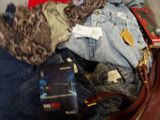 a suitcase full of clothes and a purse on the floor