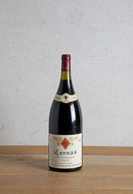 a bottle of wine sitting on a wooden table