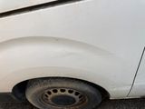 a white van that has a flat tire on the side of the road