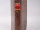 a brown book with a red label on it