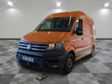 the orange van is parked on a checkered floor in the garage