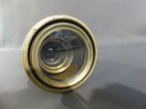 a close up of a camera lens on a table with a white background