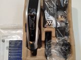 a box with a hair clipper and other items in it