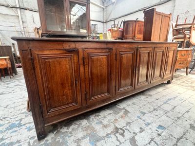 a large wooden cabinet with a mirror on top of it