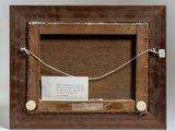 an old picture frame with a piece of paper attached to it