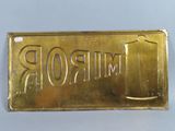 gold plated mirror sign with the word mirror on it