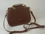 a brown purse with a gold handle on a white background