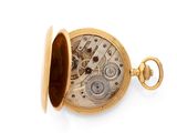 a close up of a pocket watch on a white surface