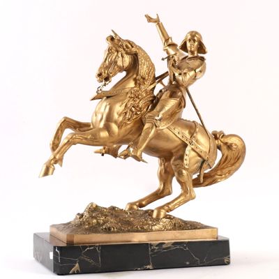 a statue of a man riding a horse with a spear