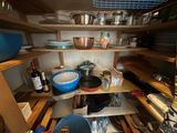 many pots and pans on the shelves in the kitchen