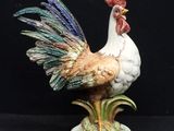 a figurine of a rooster on a black background
