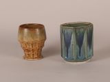 two cups sitting next to each other on a table