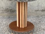 the table is made of wood and has a metal pattern on it