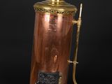 an antique copper and brass coffee pot with a brass handle