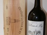 a bottle of wine sitting next to a wooden box