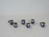 six cups that are sitting on a table