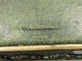an image of a close up of a green purse on a table