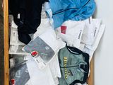 a wooden box filled with clothes on the floor