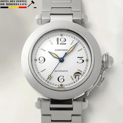 a close up of a watch on a white surface