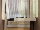 a box full of books that are stacked on top of each other