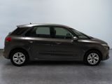 grey citrole parked in a room with a gray floor