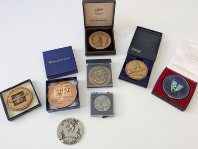 de nombreuses pièces de monnaie de toutes sortes dans une boîte posée sur une table