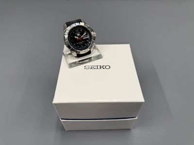 a close up of a watch in a box on a table