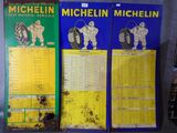 three posters of michel michel on display in a store