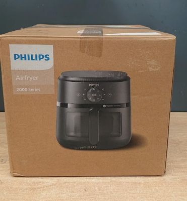 philips air fryer in a box on a wooden table