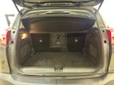 the back of a car with its trunk open and a speaker in the trunk