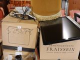 many boxes stacked on top of each other with a lamp on top of them
