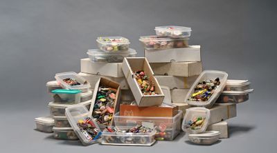 a pile of plastic containers filled with different types of beads