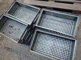 four baskets sitting on top of each other on the ground