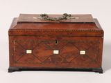 an antique wooden box with two lions on top of it