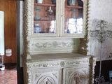 a white china cabinet in the middle of a room