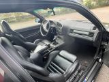 a black car with black leather seats in the back