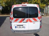 a white van with red and white stripes parked in a parking lot