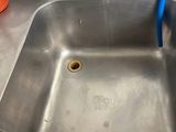 a stainless steel sink with a blue faucet in it