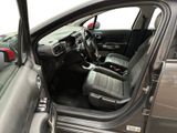 the interior of a car with the door open and the driver ' s seat down