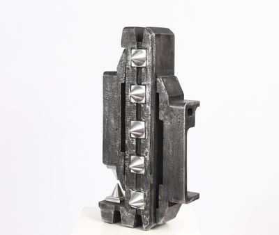 a metal object that is sitting on a white surface